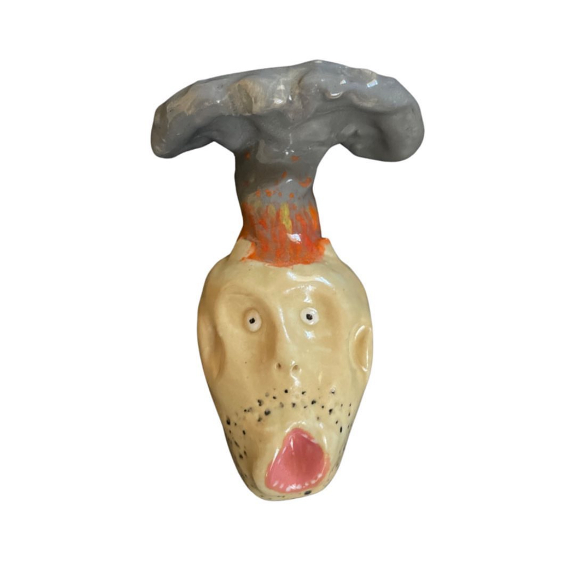 Ceramic head erupting with mushroom cloud and flames