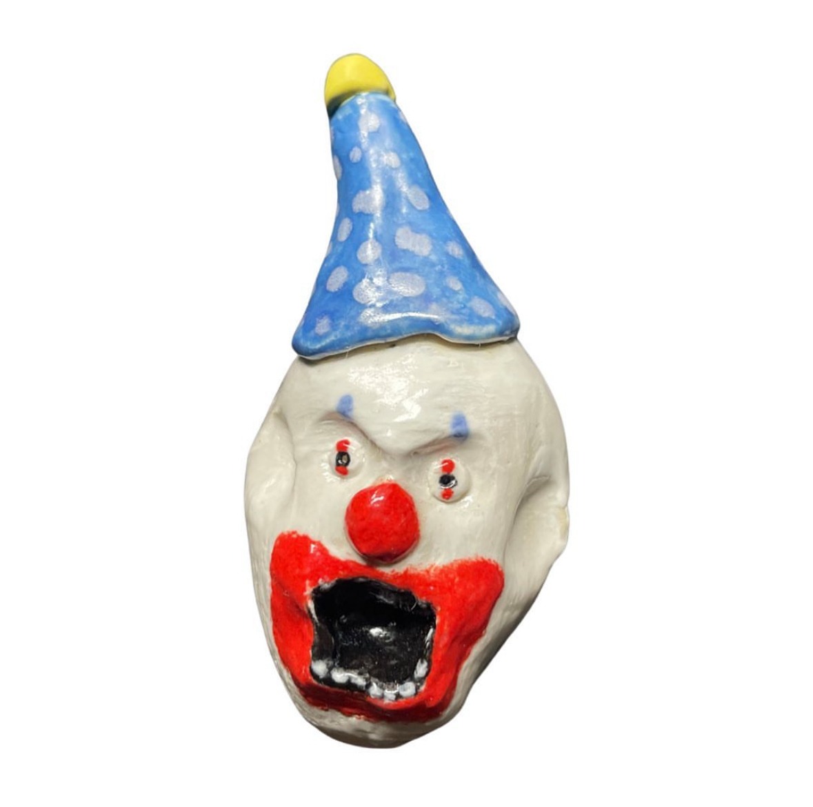 Ceramic clown head with blue polka-dot party hat and red mouth
