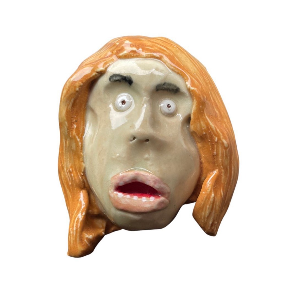 Ceramic head with long orange hair and open mouth