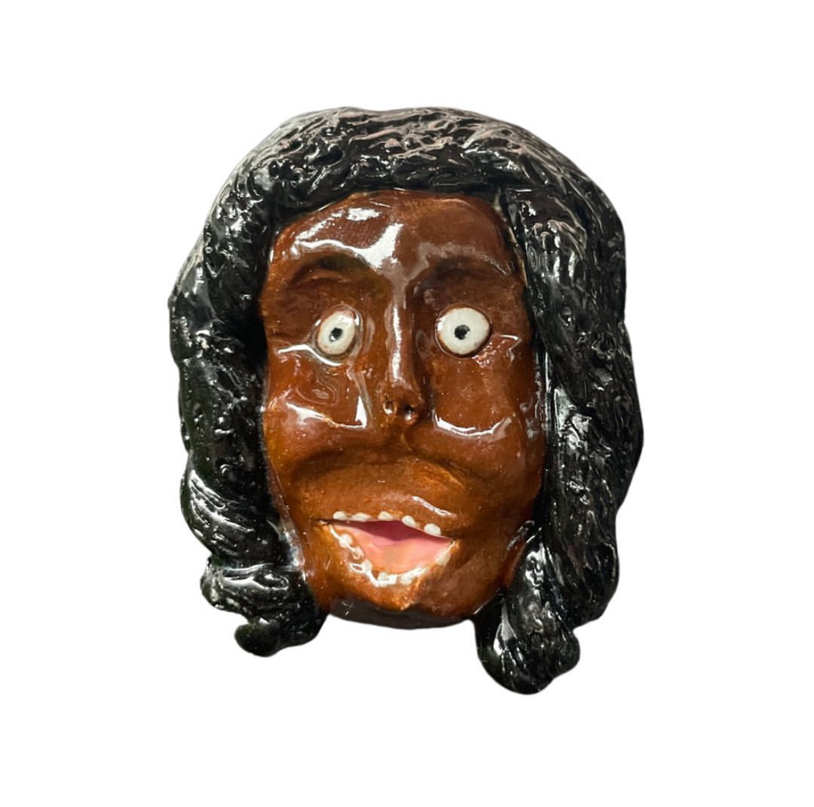 Ceramic head with long black hair smiling