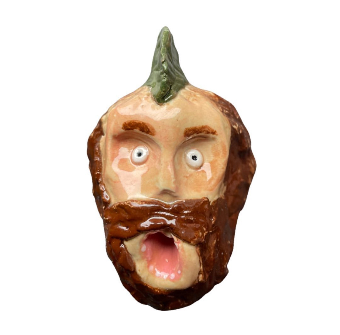Ceramic bearded head with green horn on top