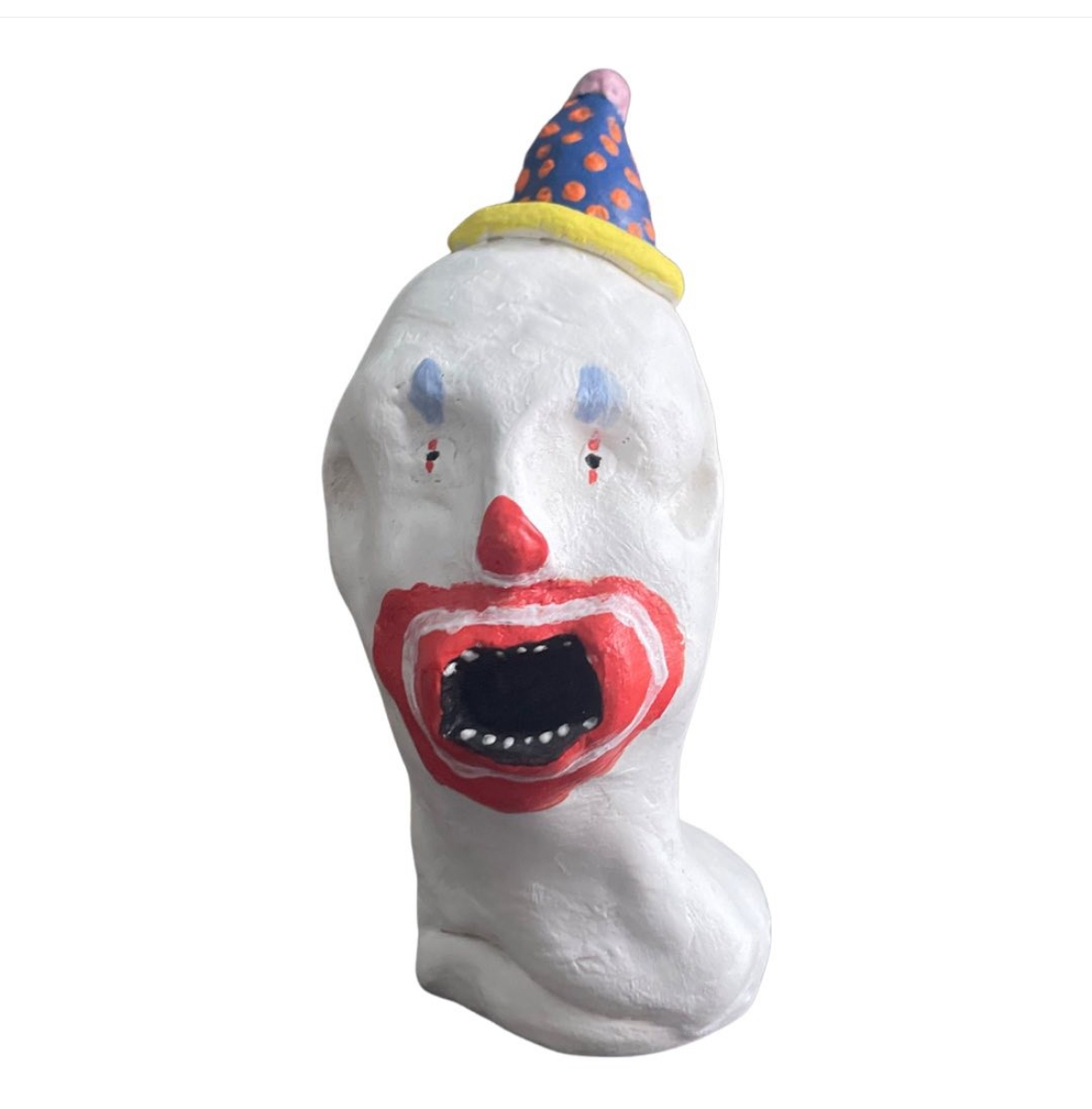 Ceramic white clown head with blue polka-dot party hat and screaming red mouth
