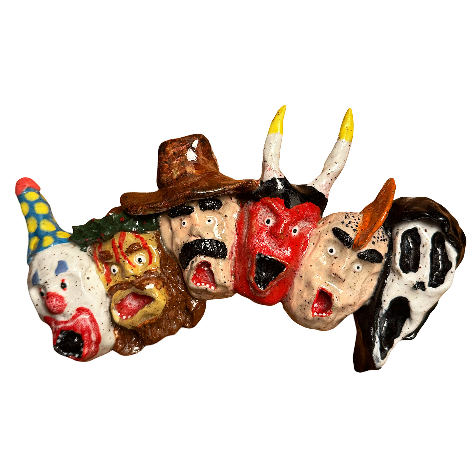 Ceramic wall sculpture with row of heads including clown, cowboy, devil and Ghostface