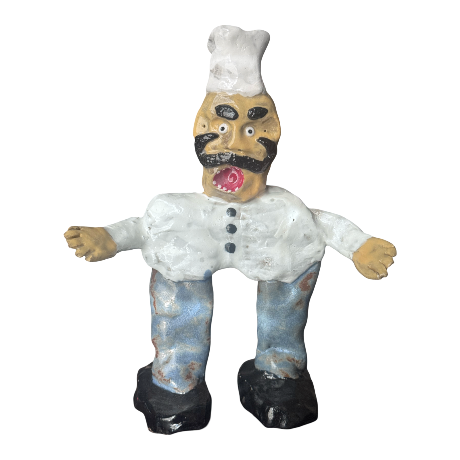 Ceramic chef figure with white toque, black mustache and blue pants