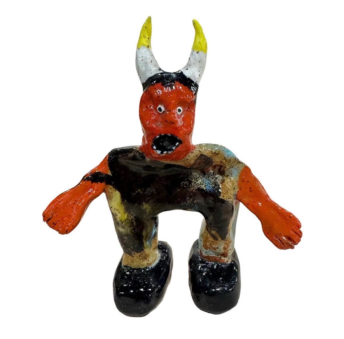 Ceramic red devil figure with yellow-tipped horns and black boots