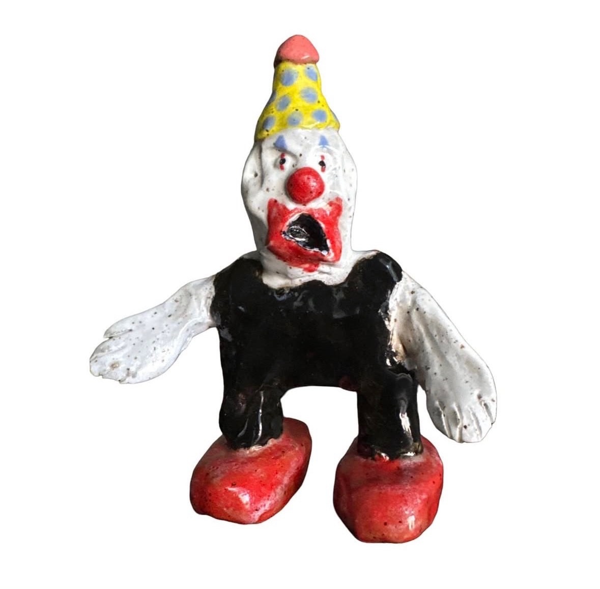 Ceramic clown figure with party hat, black shirt and red shoes