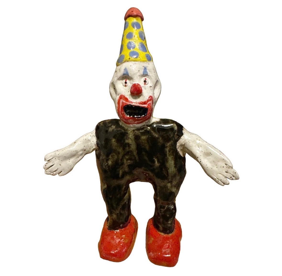 Ceramic clown figure with polka-dot hat and red shoes