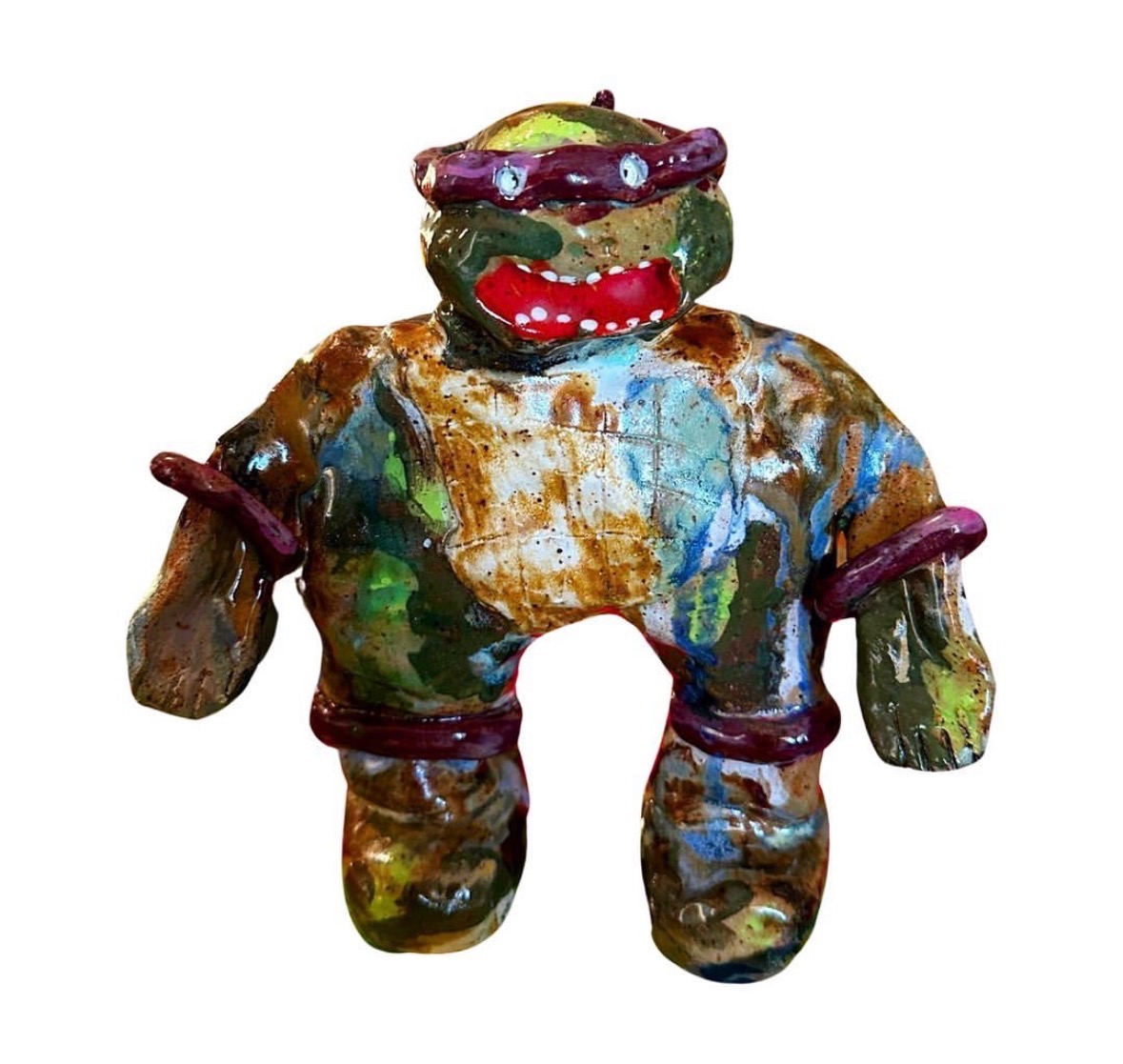 Ceramic ninja turtle figure with purple bandana and red mouth