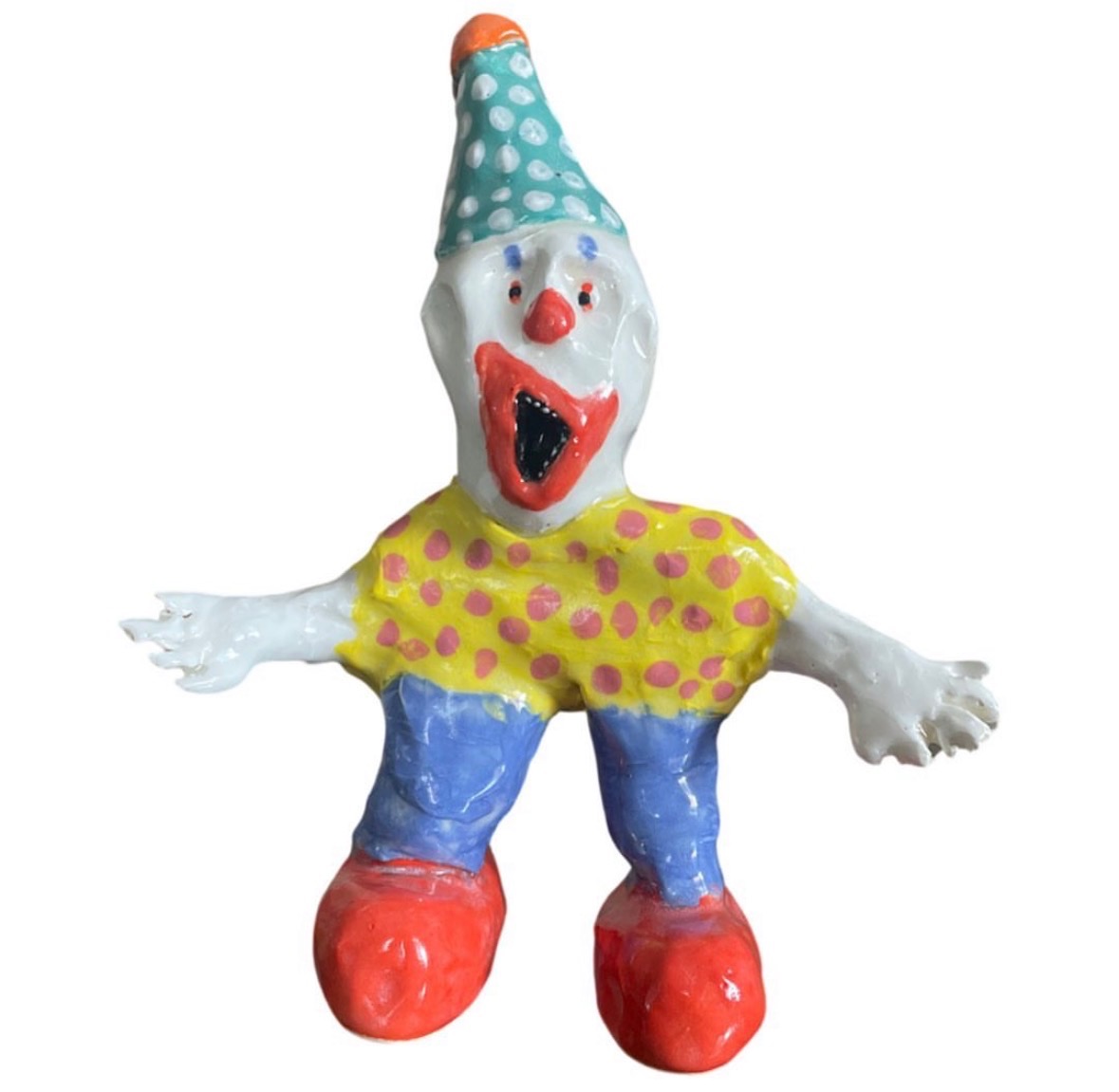 Ceramic clown figure with teal polka-dot hat, yellow polka-dot shirt and red shoes