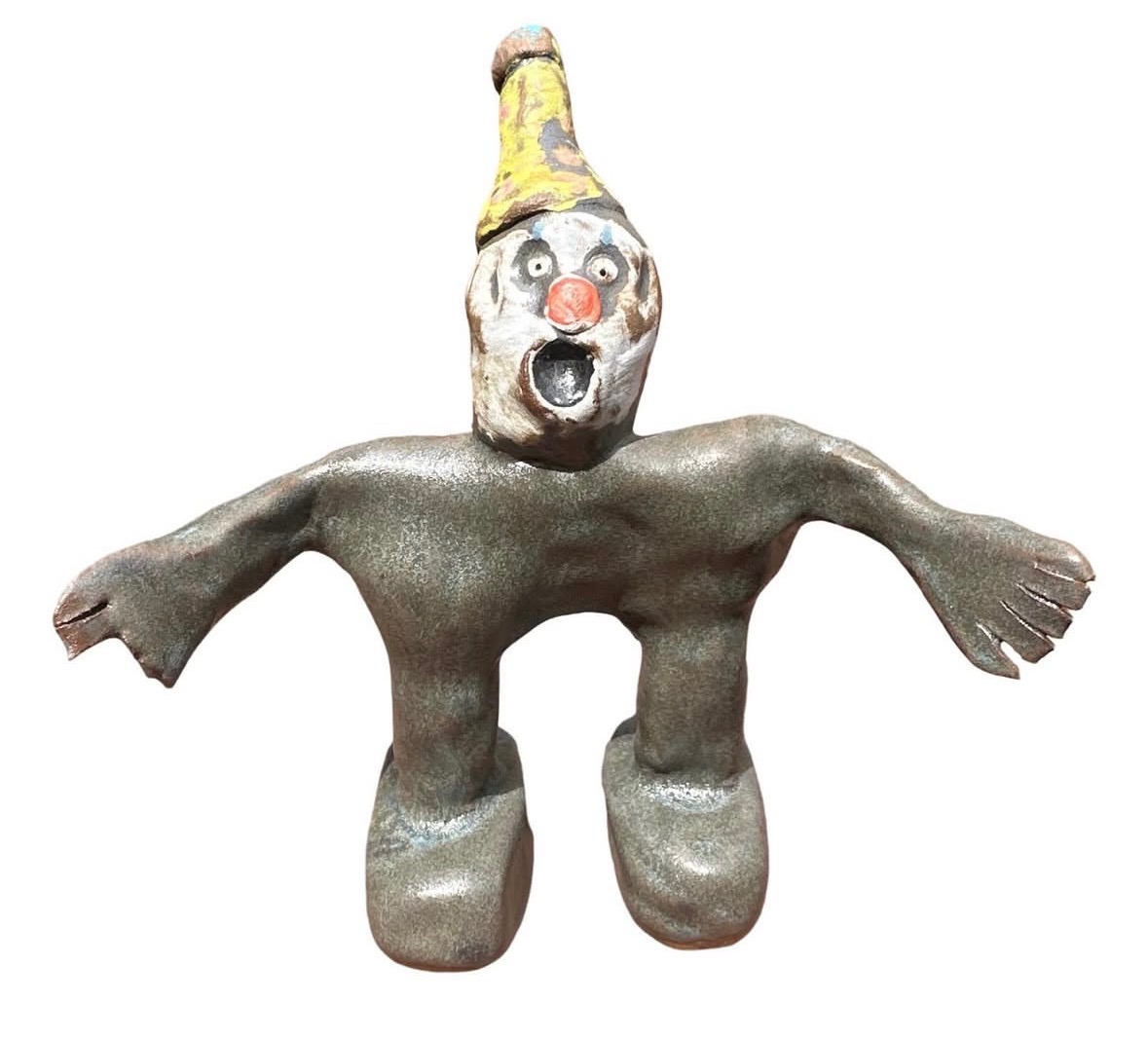 Ceramic gray clown figure with yellow party hat and screaming face