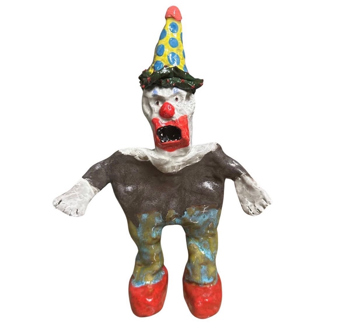 Ceramic screaming clown figure with blue and yellow polka-dot hat, brown shirt and red shoes
