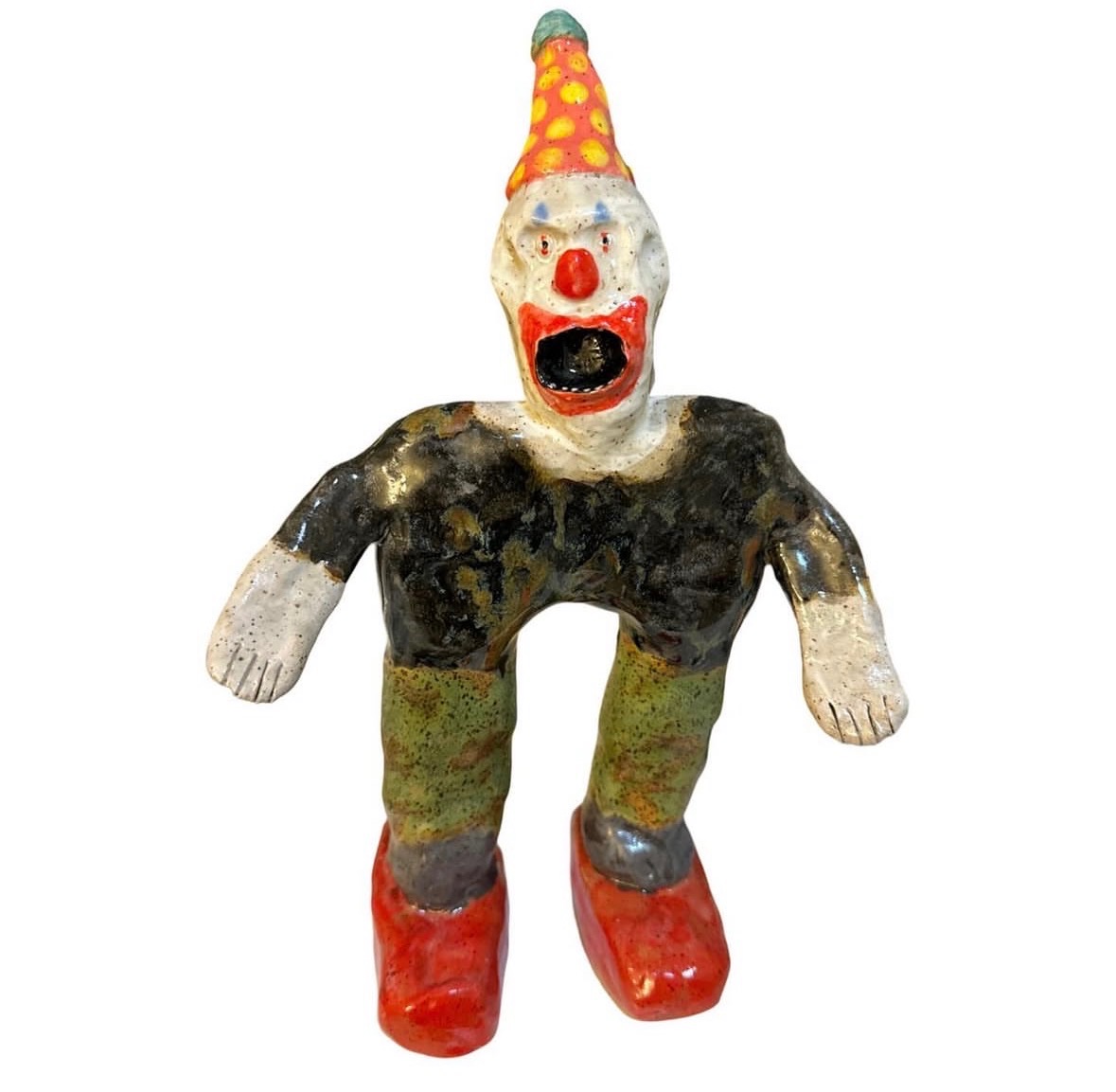 Ceramic screaming clown figure with orange polka-dot hat, dark shirt and red shoes