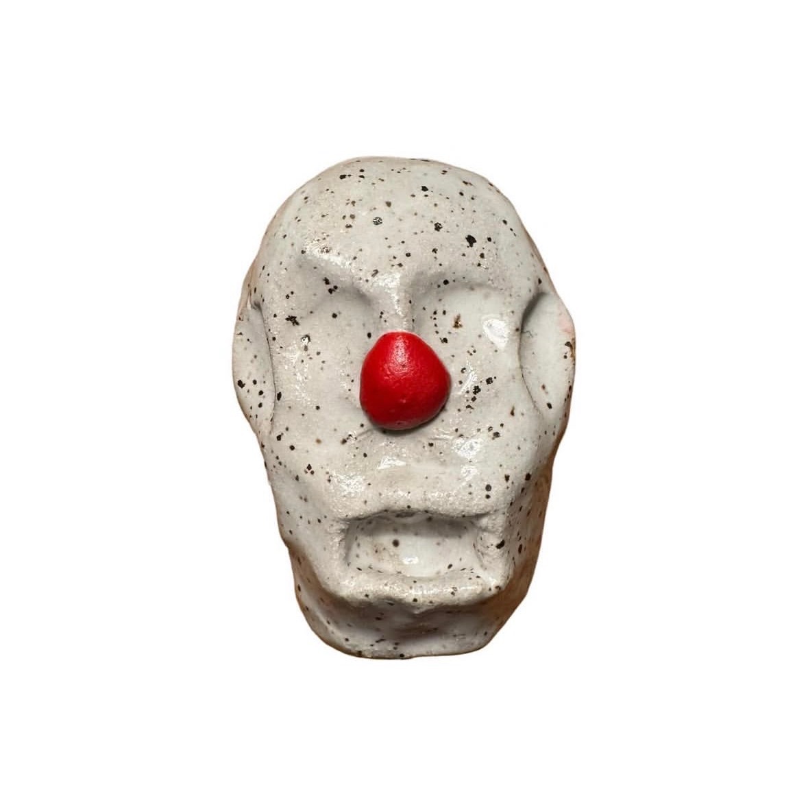 Ceramic speckled clown head with red nose and no eyes or mouth