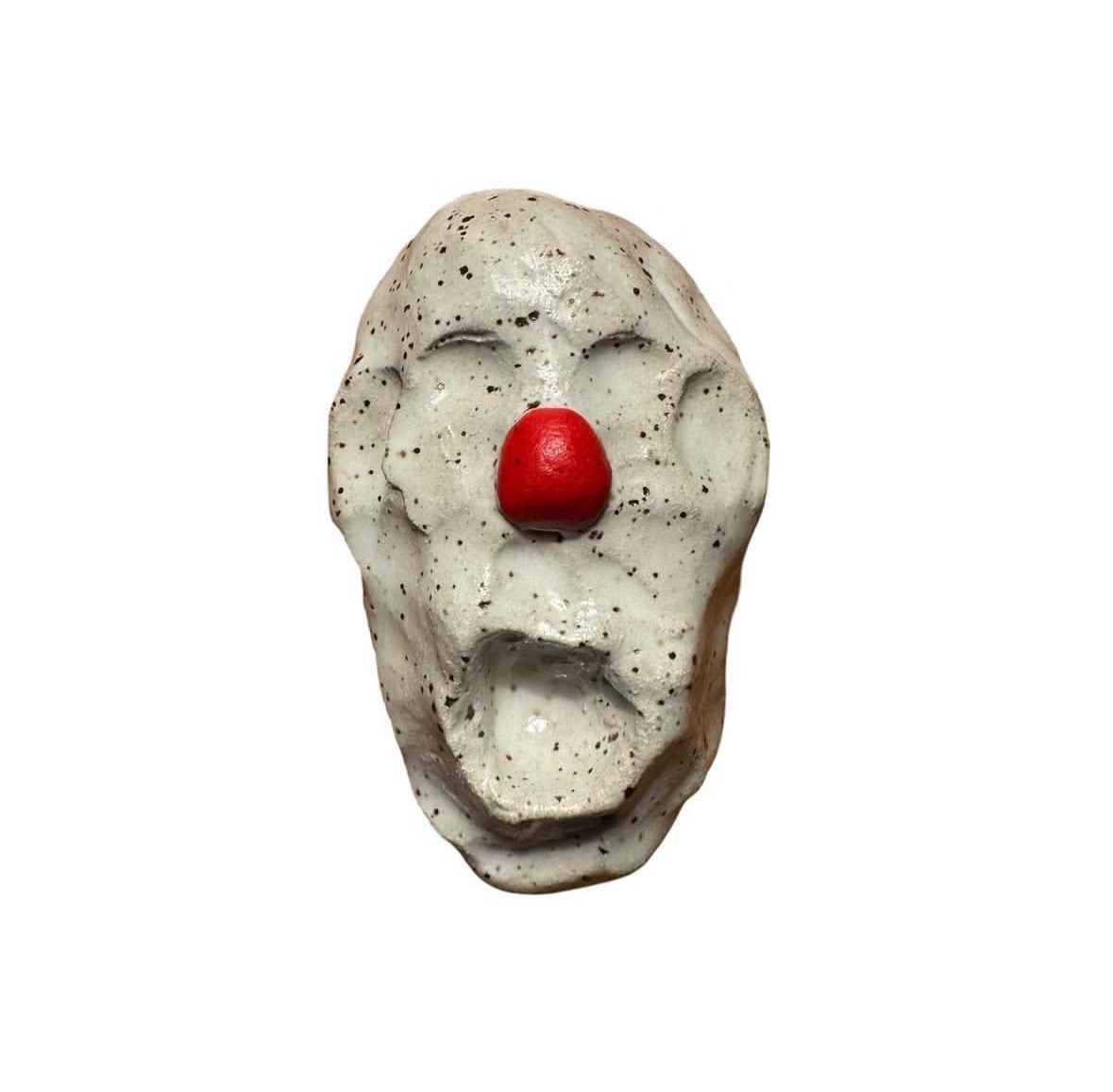 Ceramic speckled clown head with red nose and no eyes or mouth