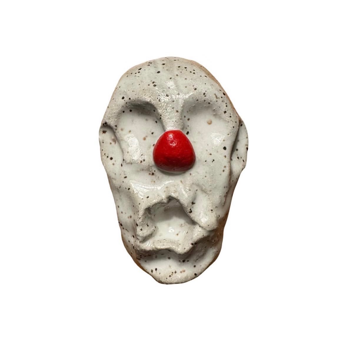 Ceramic speckled clown head with red nose and no eyes or mouth