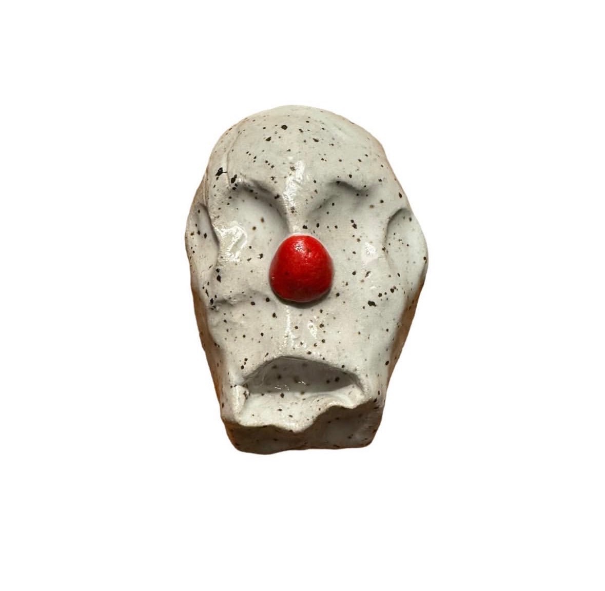 Ceramic speckled clown head with red nose and no eyes or mouth