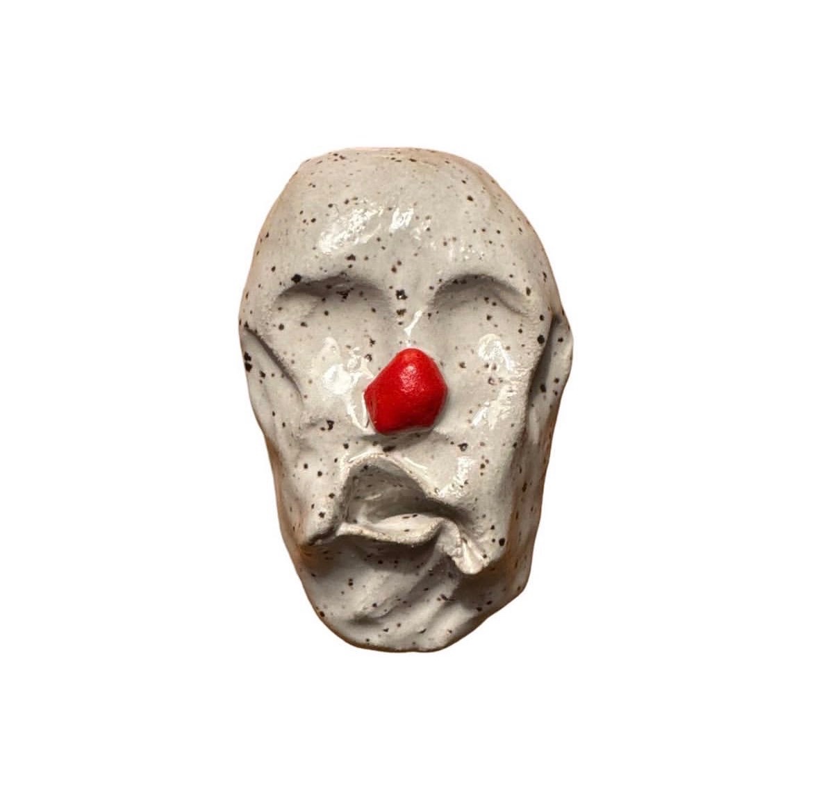 Ceramic speckled clown head with red nose and no eyes or mouth