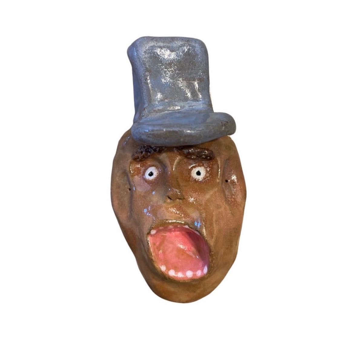 Ceramic brown head with gray top hat and screaming open mouth