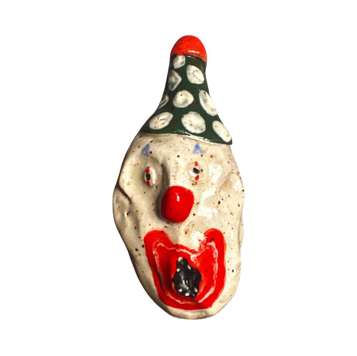 Ceramic clown head with green and white polka-dot party hat