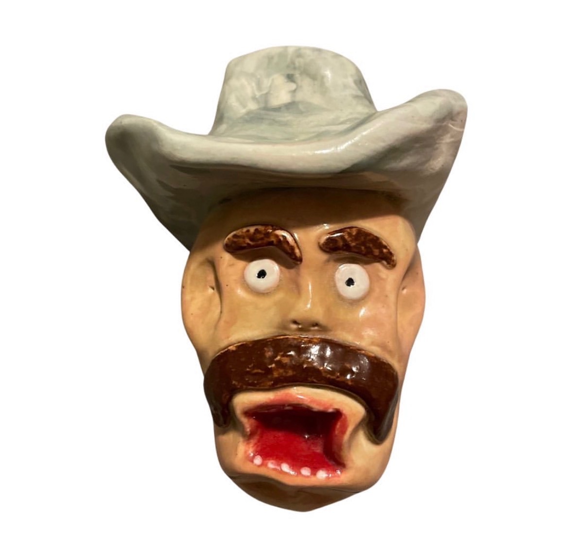 Ceramic cowboy head with white hat, brown mustache and screaming open red mouth