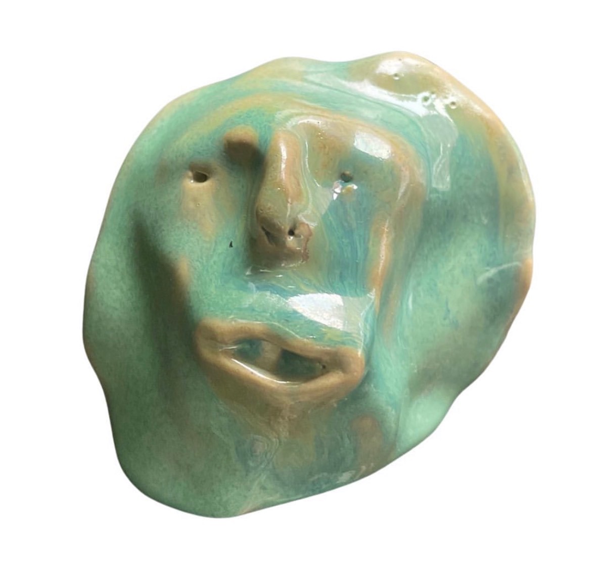 Ceramic green-glazed face sculpture with parted lips