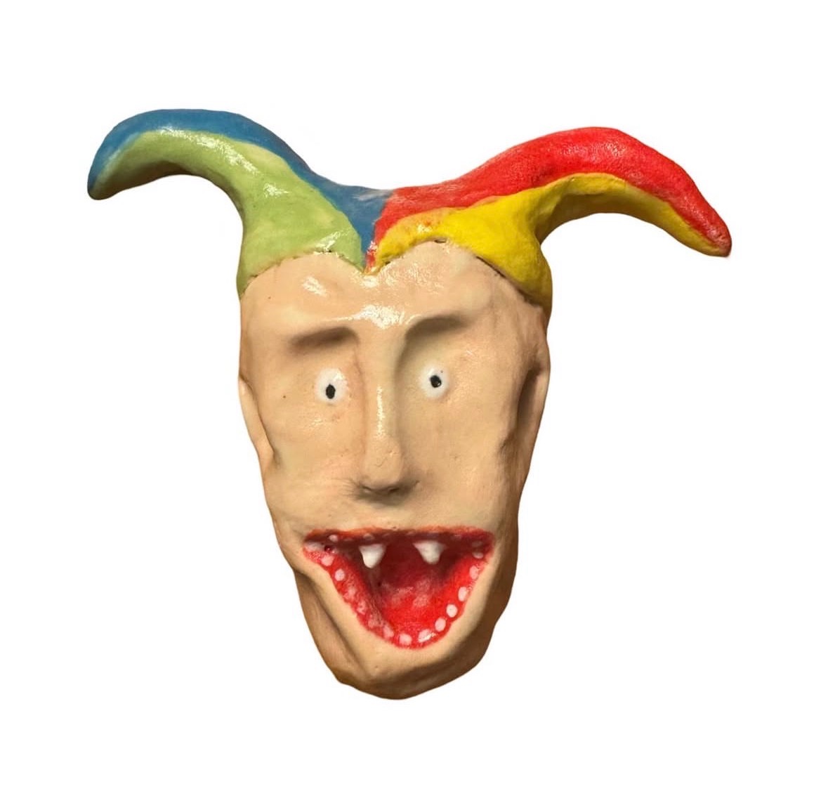 Ceramic head with rainbow jester hat with pointed flaps and open red mouth showing teeth