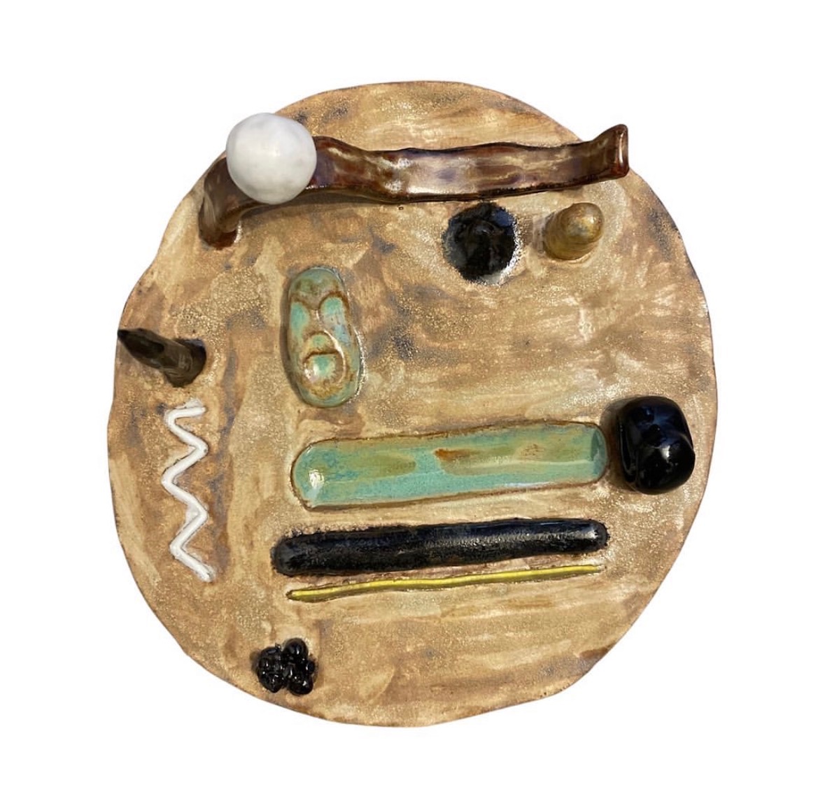 Ceramic landscape sculpture top-down view with abstract elements on tan base