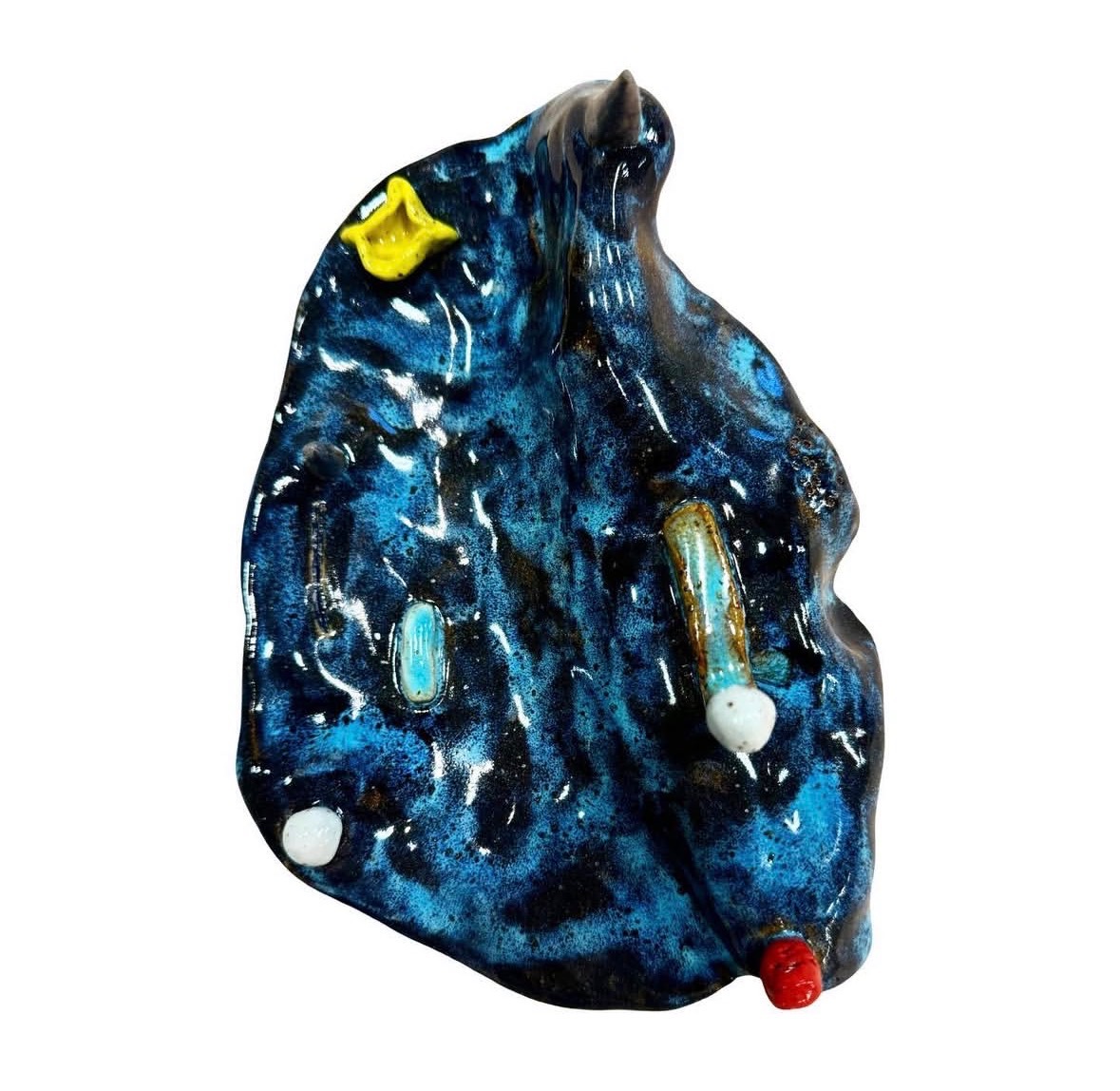 Ceramic blue-glazed landscape sculpture top-down view with spire, yellow vessel and small elements