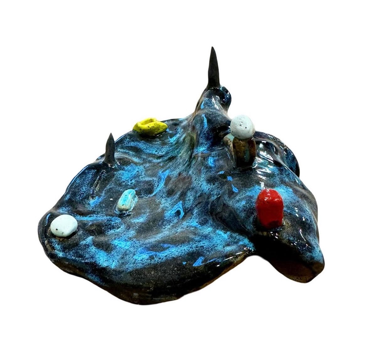 Ceramic blue-glazed landscape sculpture alternate side view with spires, yellow vessel and red figure
