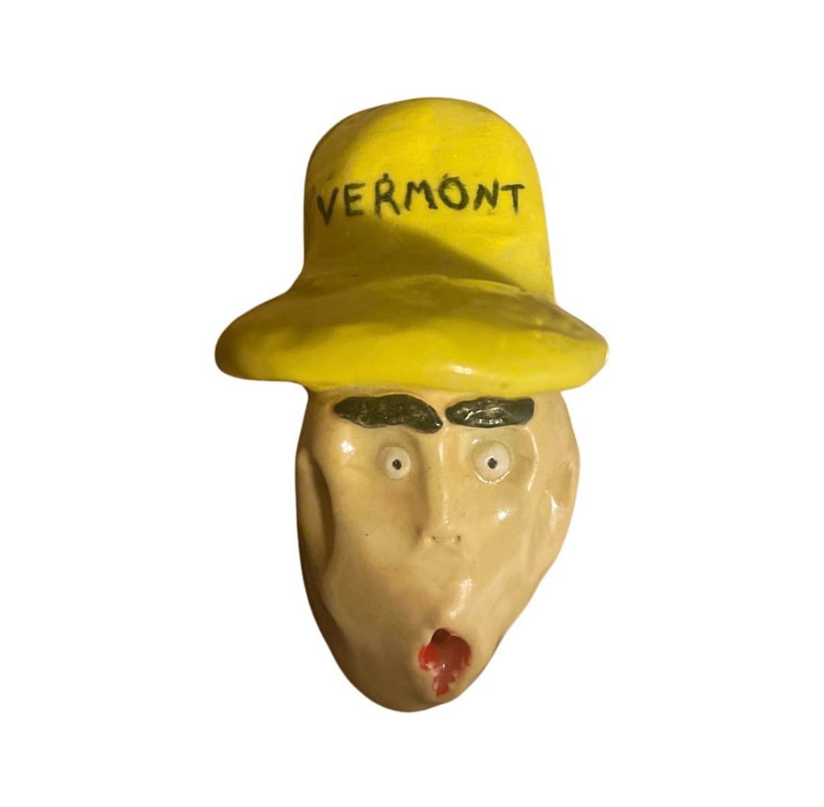 Ceramic head with yellow Vermont cap, dark eyebrows and small open red mouth