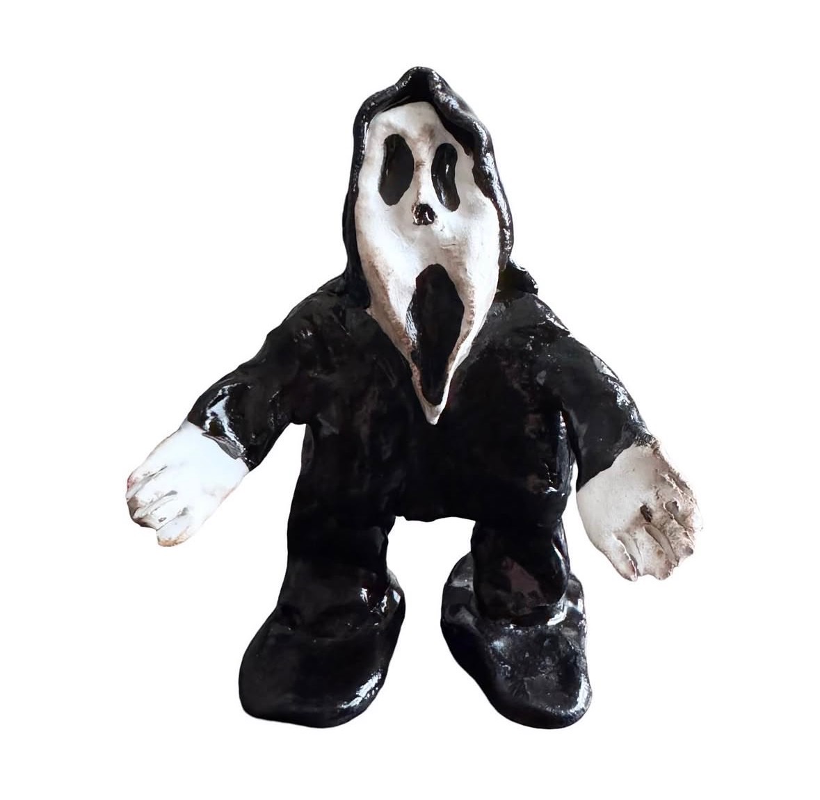 Ceramic Ghostface figure in black hooded robe with white hands and feet