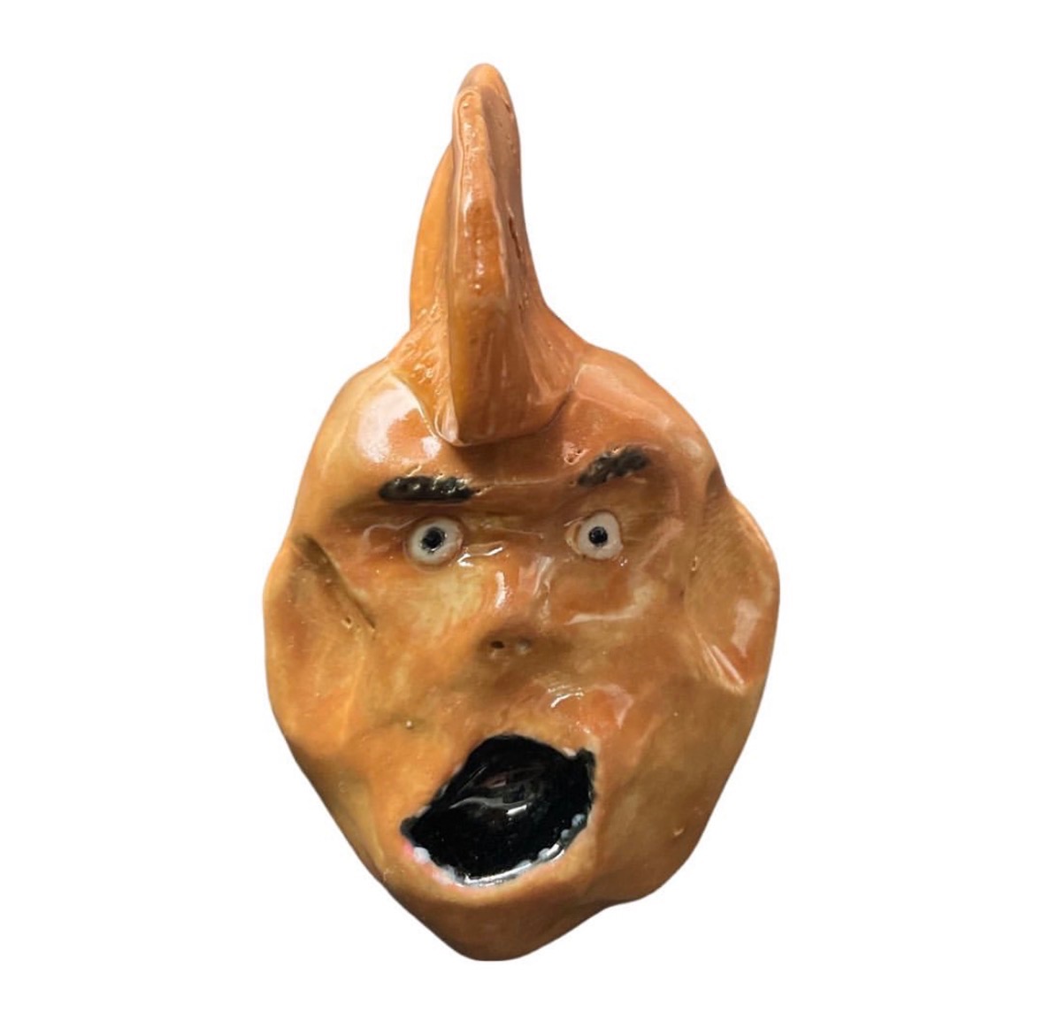 Ceramic orange head with tall mohawk and screaming open mouth