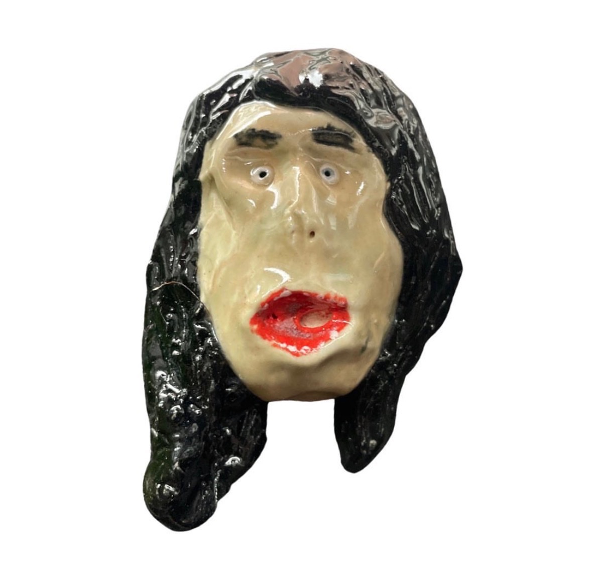 Ceramic head with long black hair and red lips