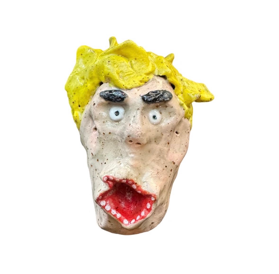 Ceramic head with messy yellow hair, dark eyebrows and screaming red mouth