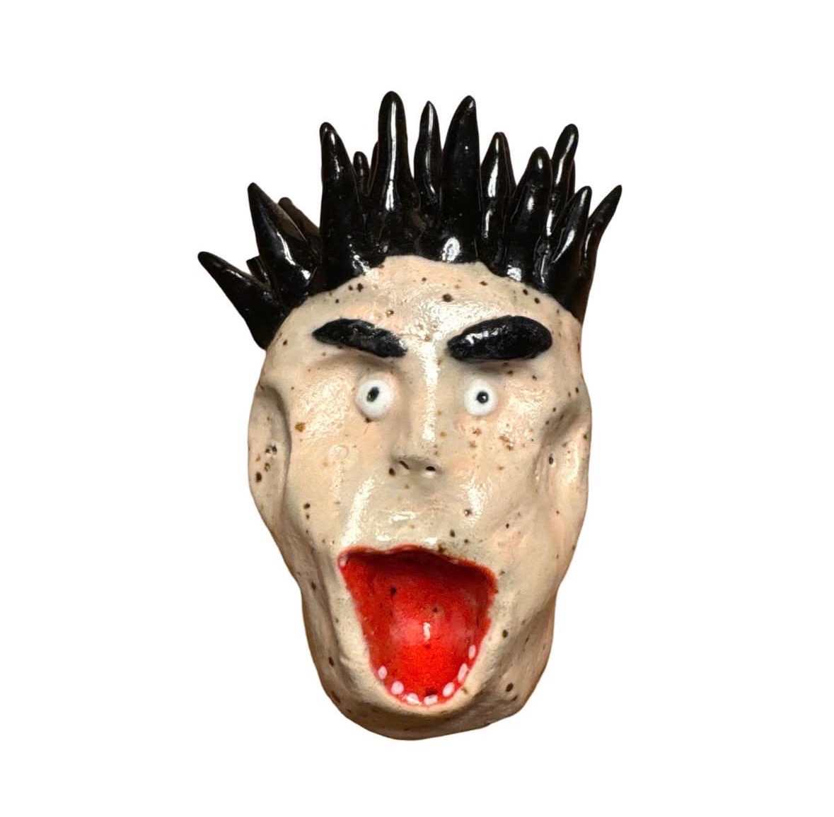 Ceramic head with spiky black hair, dark eyebrows and wide open red mouth