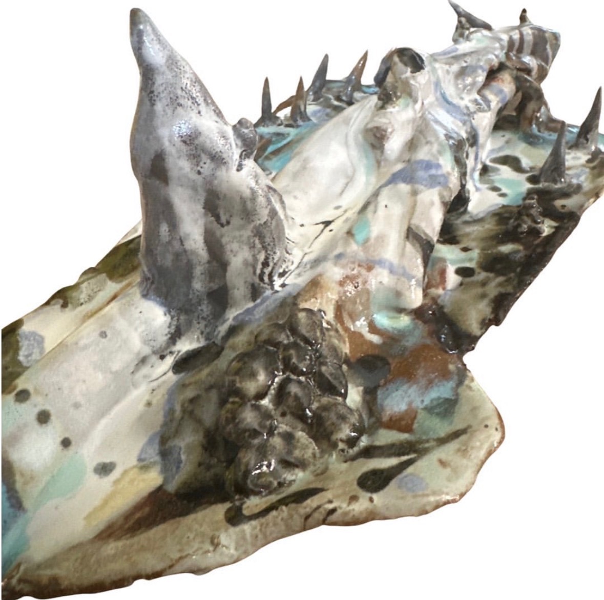 Close-up detail of ceramic ridge sculpture showing peak and textured glaze