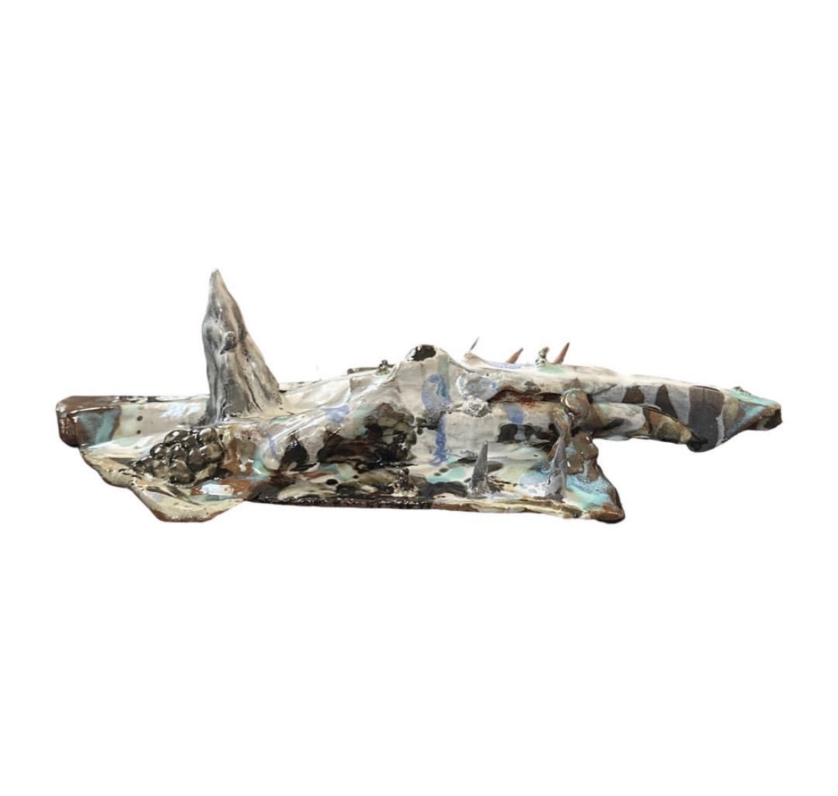 Ceramic ridge sculpture side view with peaked spire and multicolor glaze