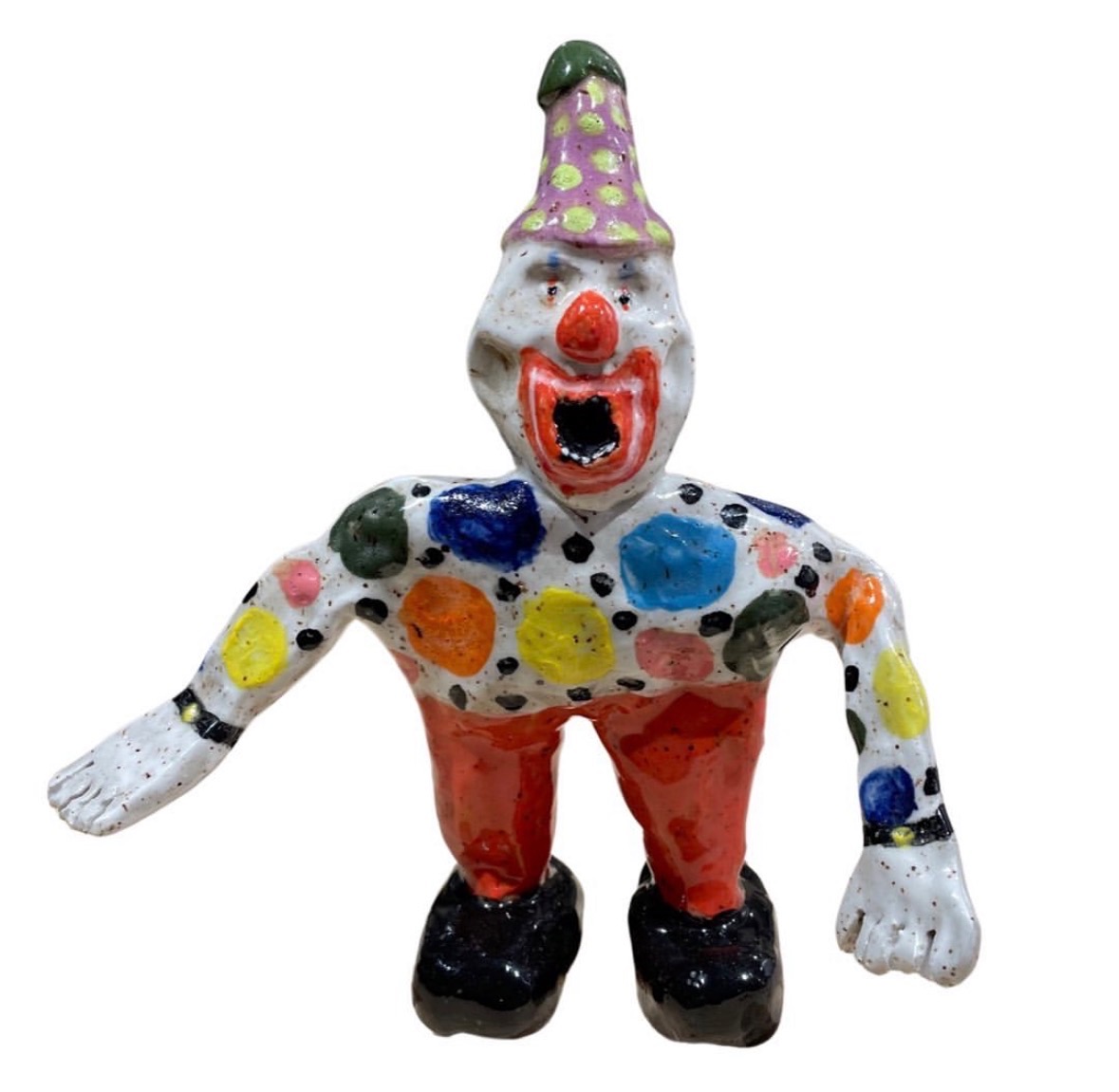 Ceramic clown figure with polka-dot suit, purple party hat, two wristwatches and red pants